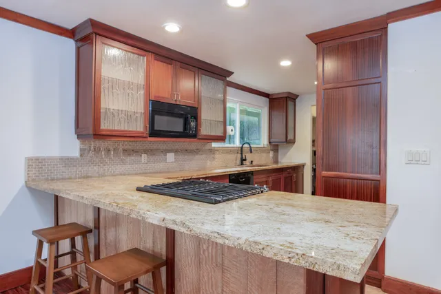 a kitchen with kitchen island a sink table and chairs