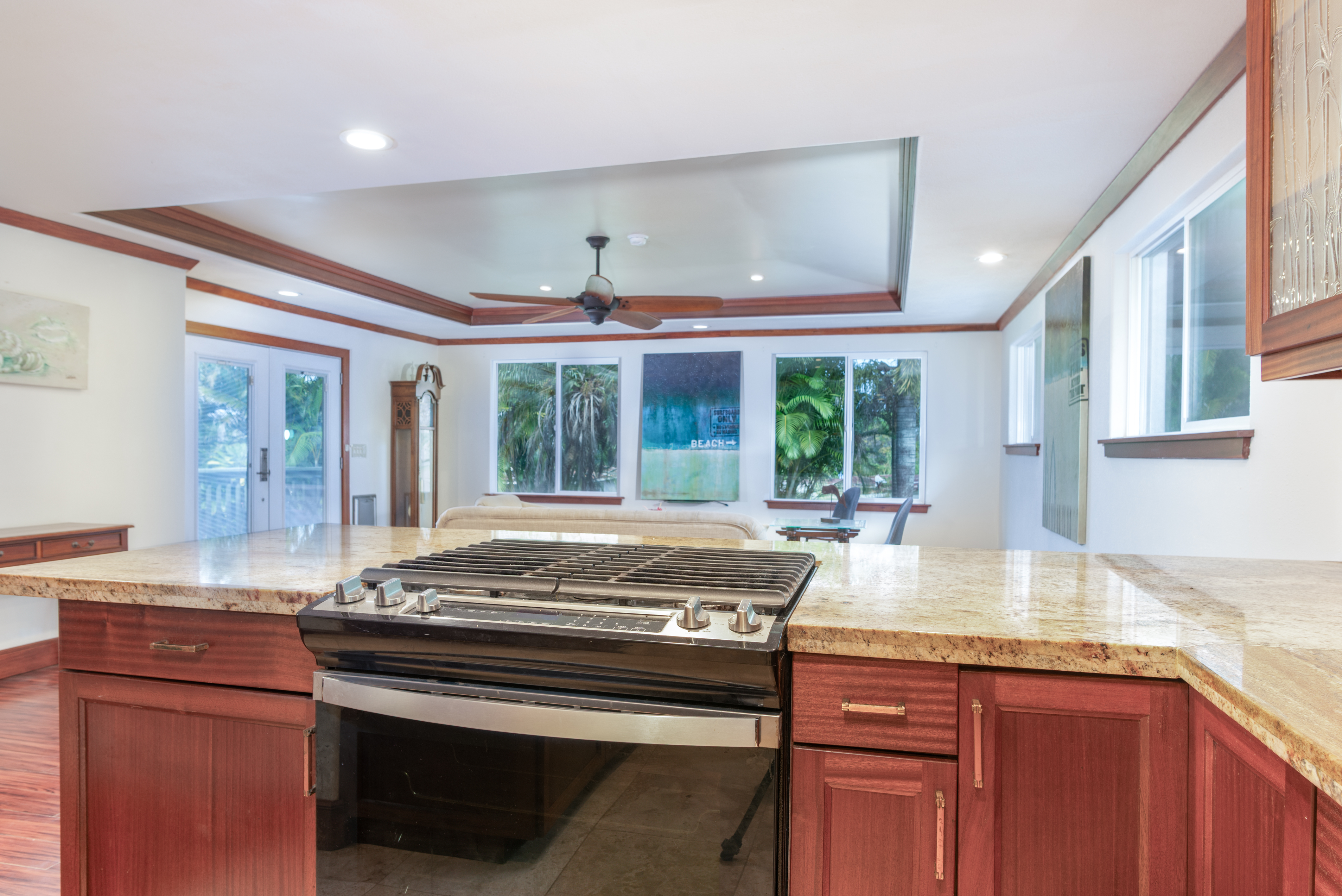 45-464 Maile Street Honokaa, HI 96727 - Photo 8 of 28 a kitchen with kitchen island granite countertop a stove and a sink