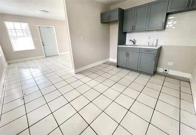a kitchen with a sink and cabinets
