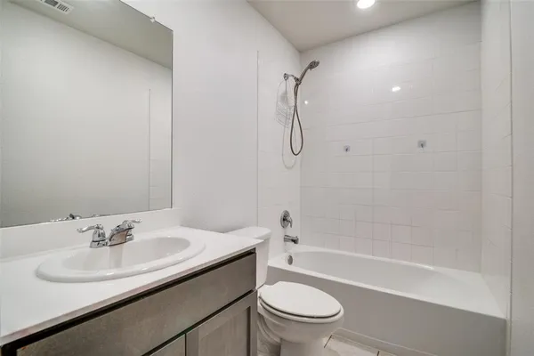 a bathroom with a sink toilet vanity and shower