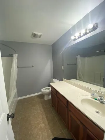 a bathroom with a sink toilet and a mirror