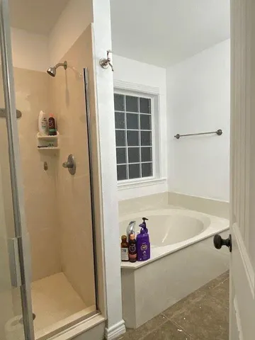 a bath room with a bathtub and a shower