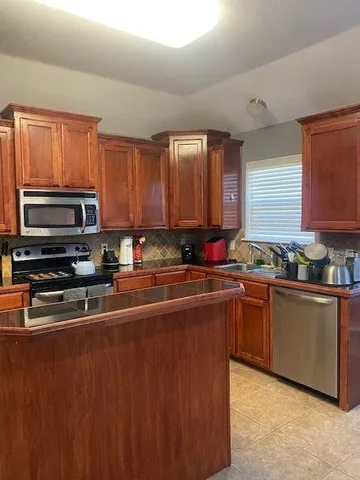 a kitchen with stainless steel appliances and cabinets