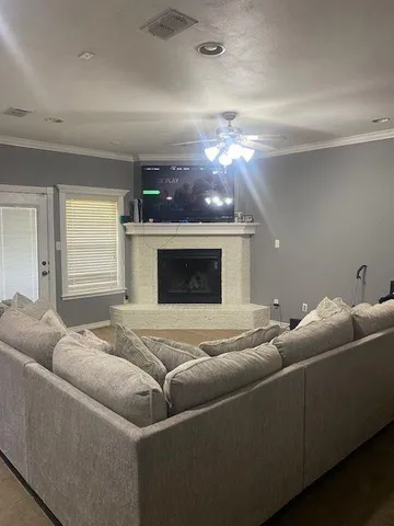 a living room with furniture and a fireplace