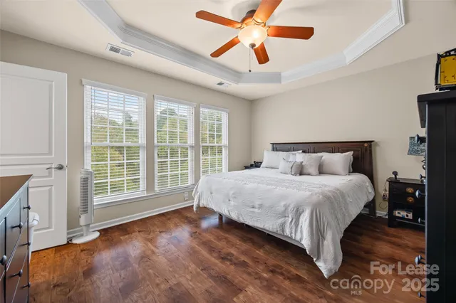 a spacious bathroom with a double vanity sink a mirror and a toilet