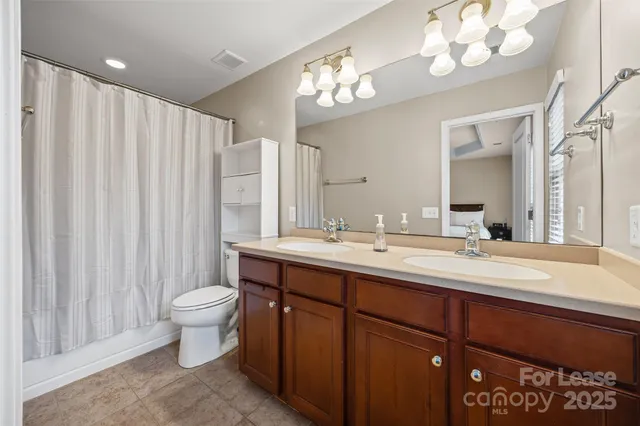 a view of walk in closet with clothes