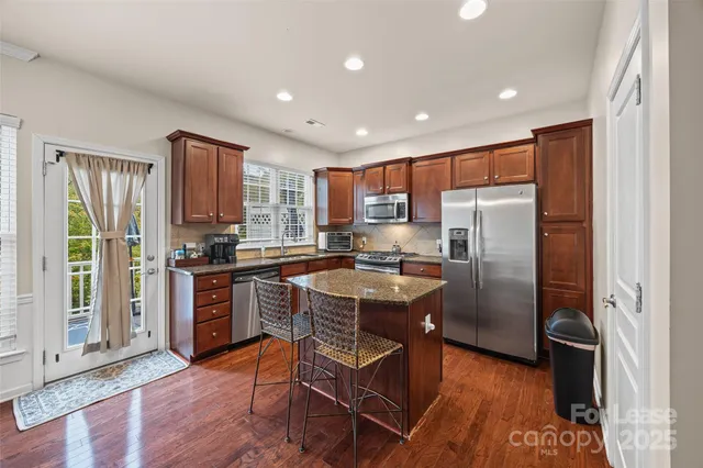 a view of a kitchen area with furniture and wooden floor