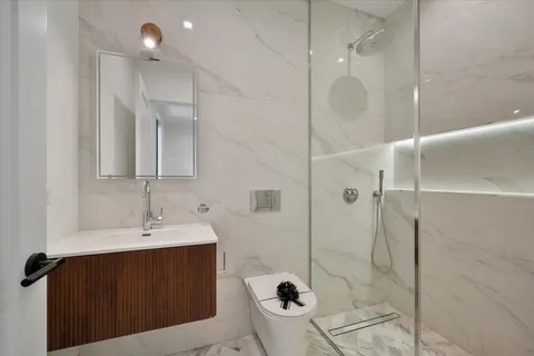 a bathroom with a sink mirror and toilet