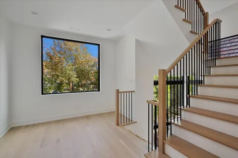 an aerial view of residential houses with outdoor space and trees