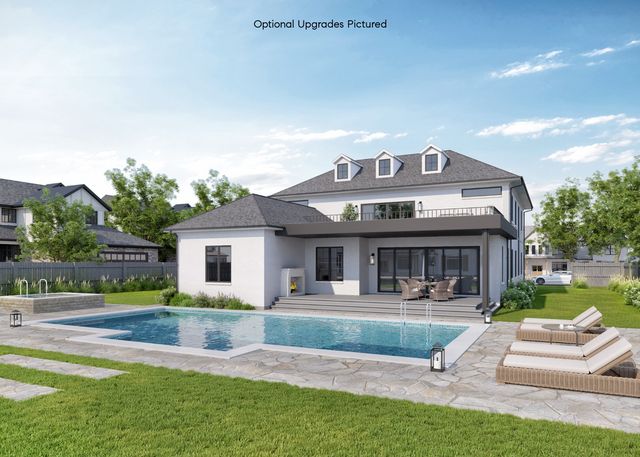 a front view of a house with garden and sitting area