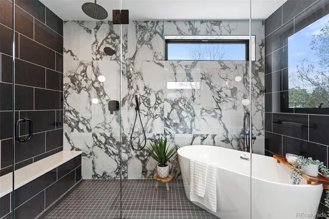 a bathroom with a bathtub and shower