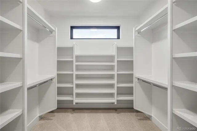 a view of walk in closet with empty racks