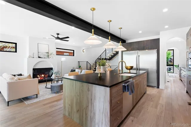a kitchen with stainless steel appliances kitchen island a large island in the center