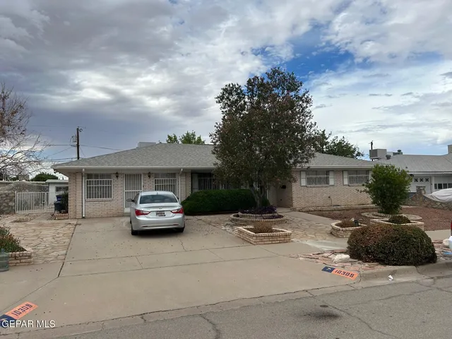 a car parked in front of white house