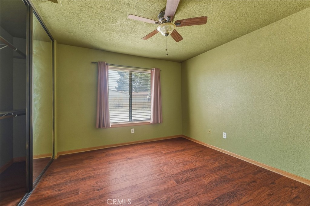 19501 Kinai Road Apple Valley, CA 92307 - Photo 35 of 49 an empty room with wooden floor and windows