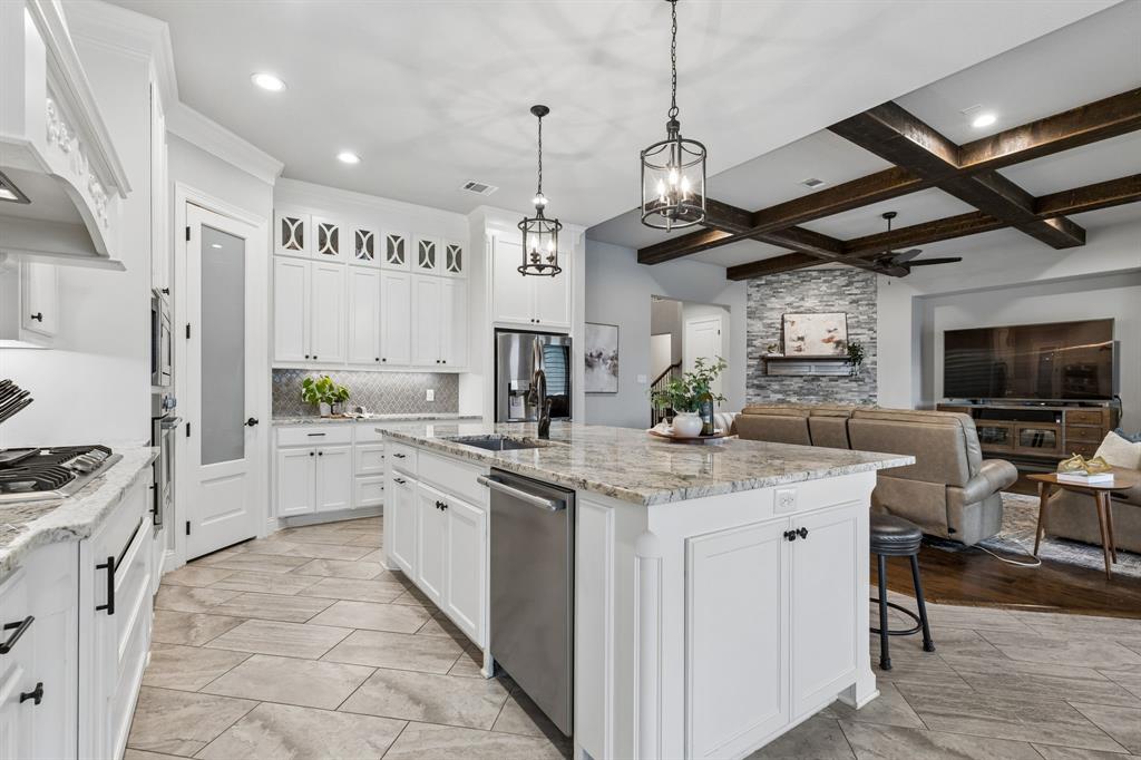 104 Ryder Court Hurst, TX 76053 - Photo 11 of 35 Chef’s Kitchen With Oversized Island, Custom Cabinetry, And Gas Cooktop