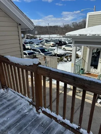 a view of a balcony with furniture and wooden floor