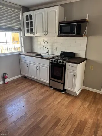 a kitchen with stainless steel appliances a stove a microwave and cabinets