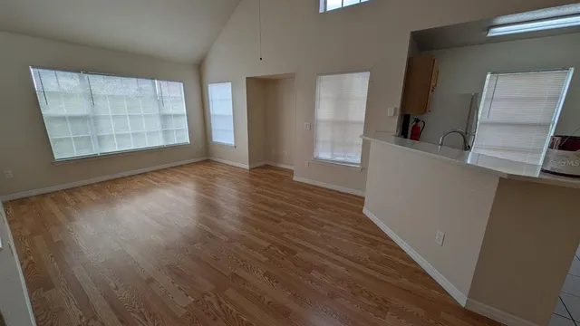 a view of a kitchen with wooden floor and a sink