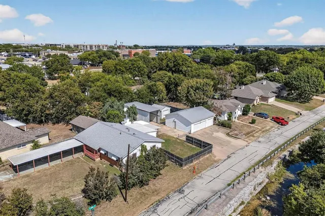 an aerial view of a house with a yard basket ball court and outdoor seating