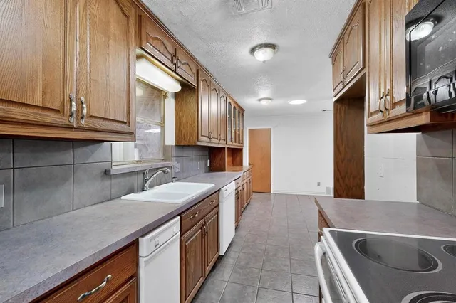 a kitchen with stainless steel appliances granite countertop a sink and a stove