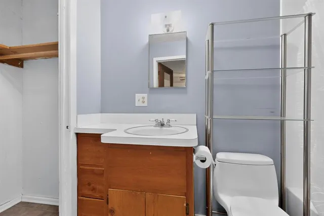 a bathroom with a sink a toilet a shower and a mirror