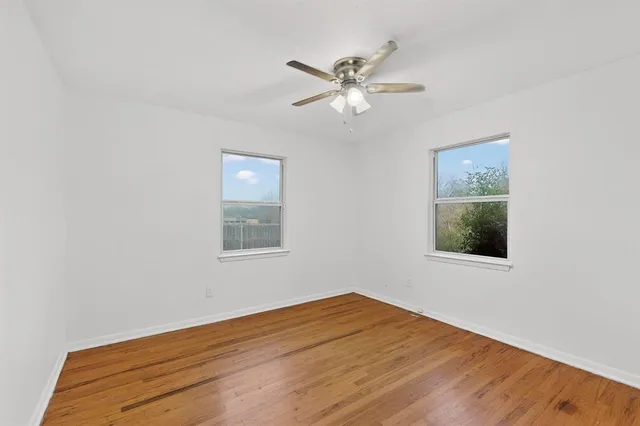 a view of a room with wooden floor and window