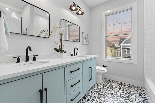 a bathroom with a sink a toilet and a mirror