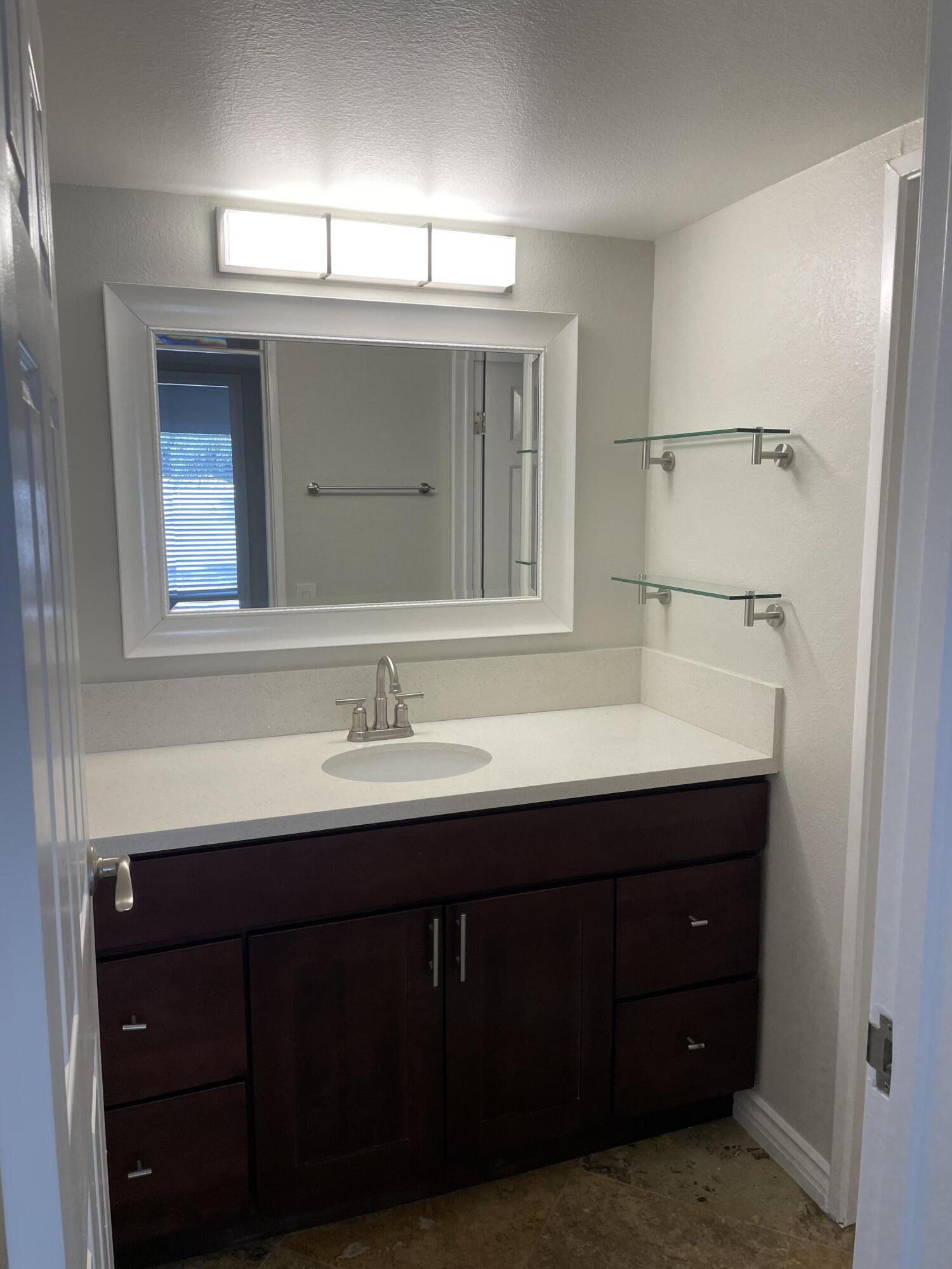 43376 Cook Street, Unit 52 Palm Desert, CA 92211 - Photo 17 of 42 a bathroom with a sink and a mirror