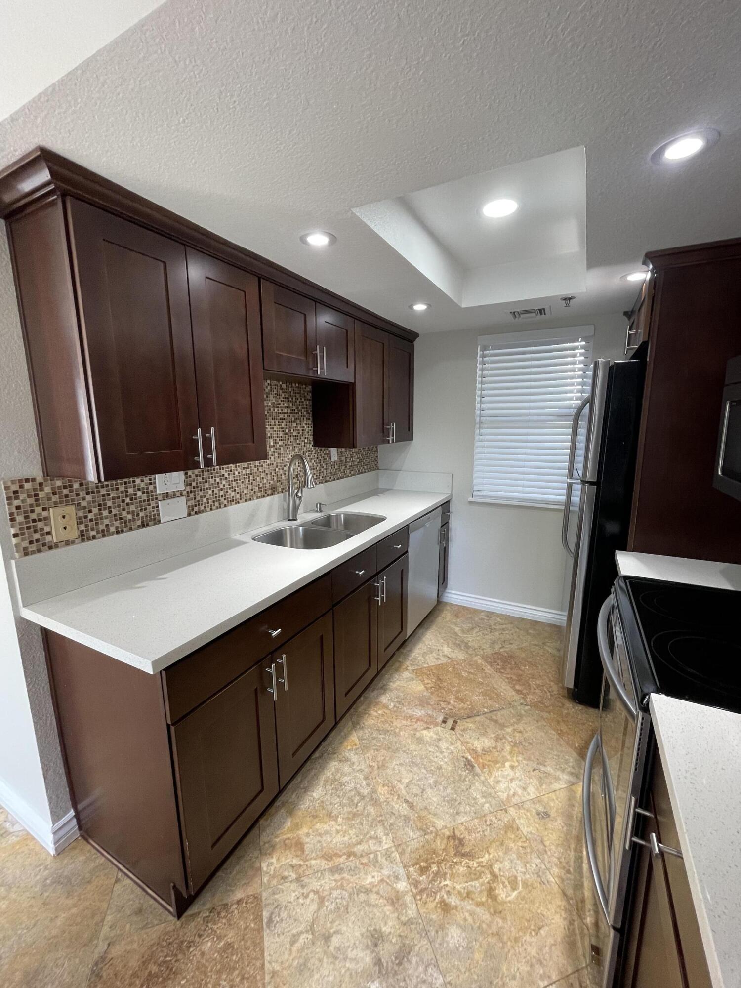 43376 Cook Street, Unit 52 Palm Desert, CA 92211 - Photo 2 of 42 a kitchen with a sink appliances and cabinets