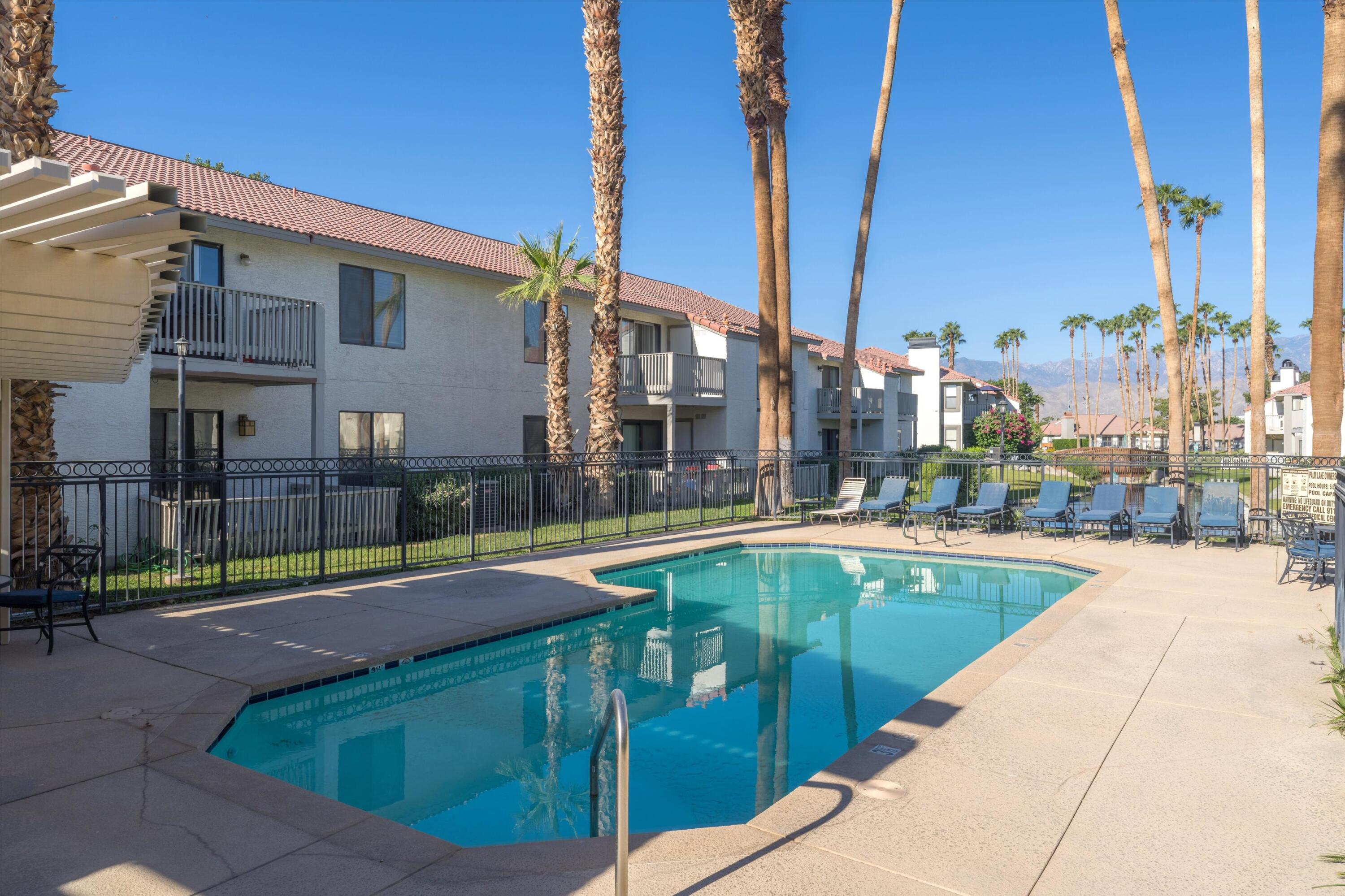 43376 Cook Street, Unit 52 Palm Desert, CA 92211 - Photo 34 of 42 a view of swimming pool with outdoor seating and city view