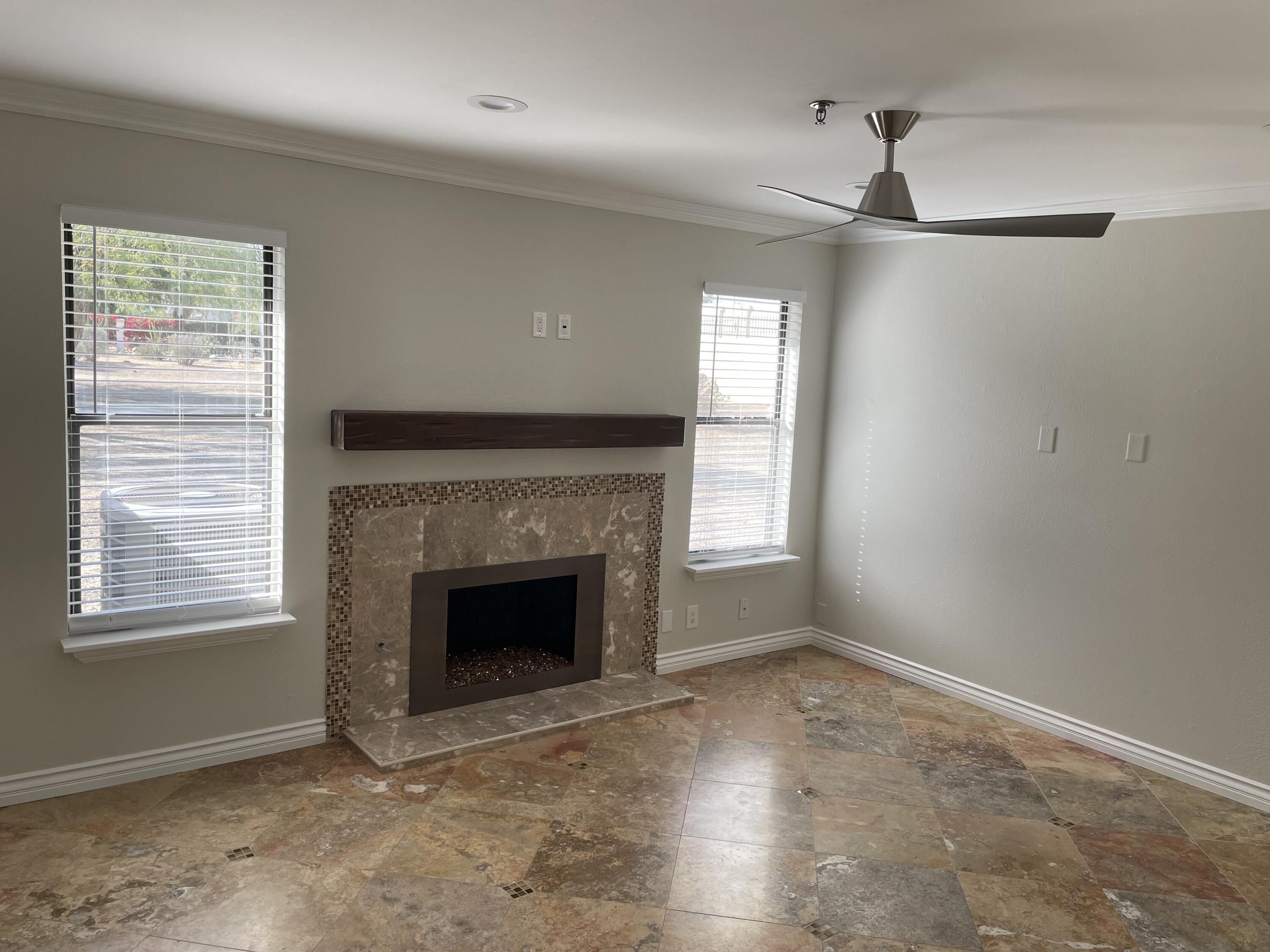 43376 Cook Street, Unit 52 Palm Desert, CA 92211 - Photo 4 of 42 a view of empty room with fireplace and windows