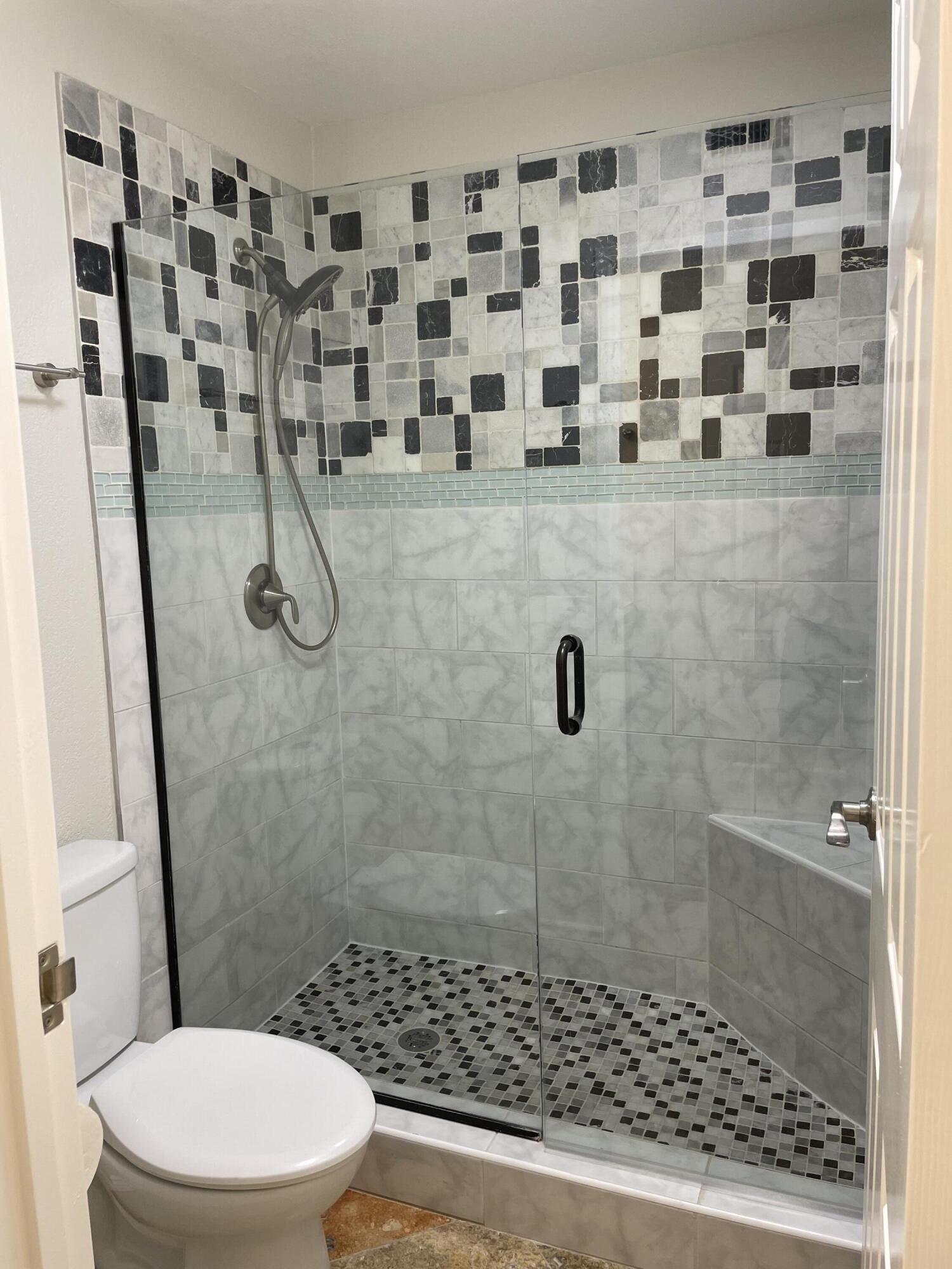 43376 Cook Street, Unit 52 Palm Desert, CA 92211 - Photo 5 of 42 a bathroom with a toilet and a shower