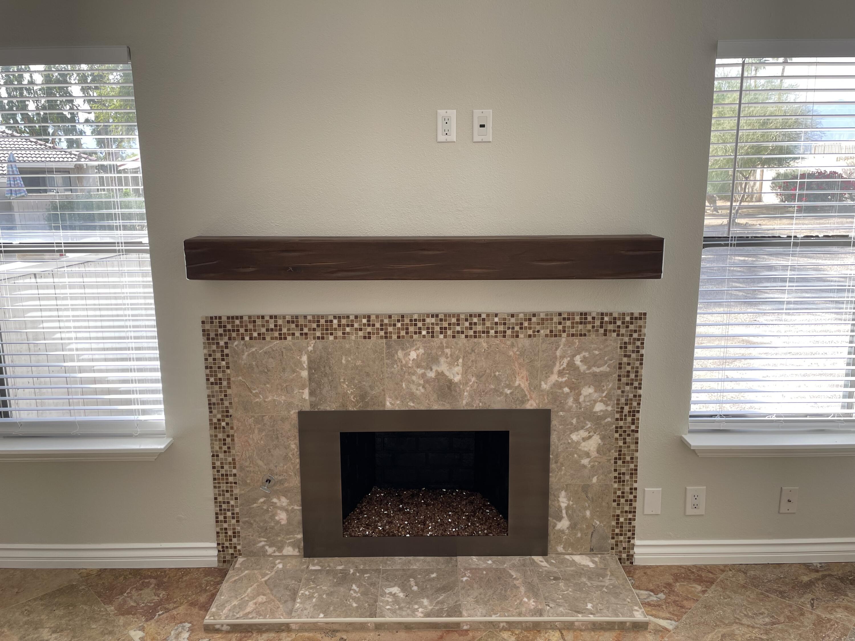 43376 Cook Street, Unit 52 Palm Desert, CA 92211 - Photo 6 of 42 a living room with a fireplace and windows