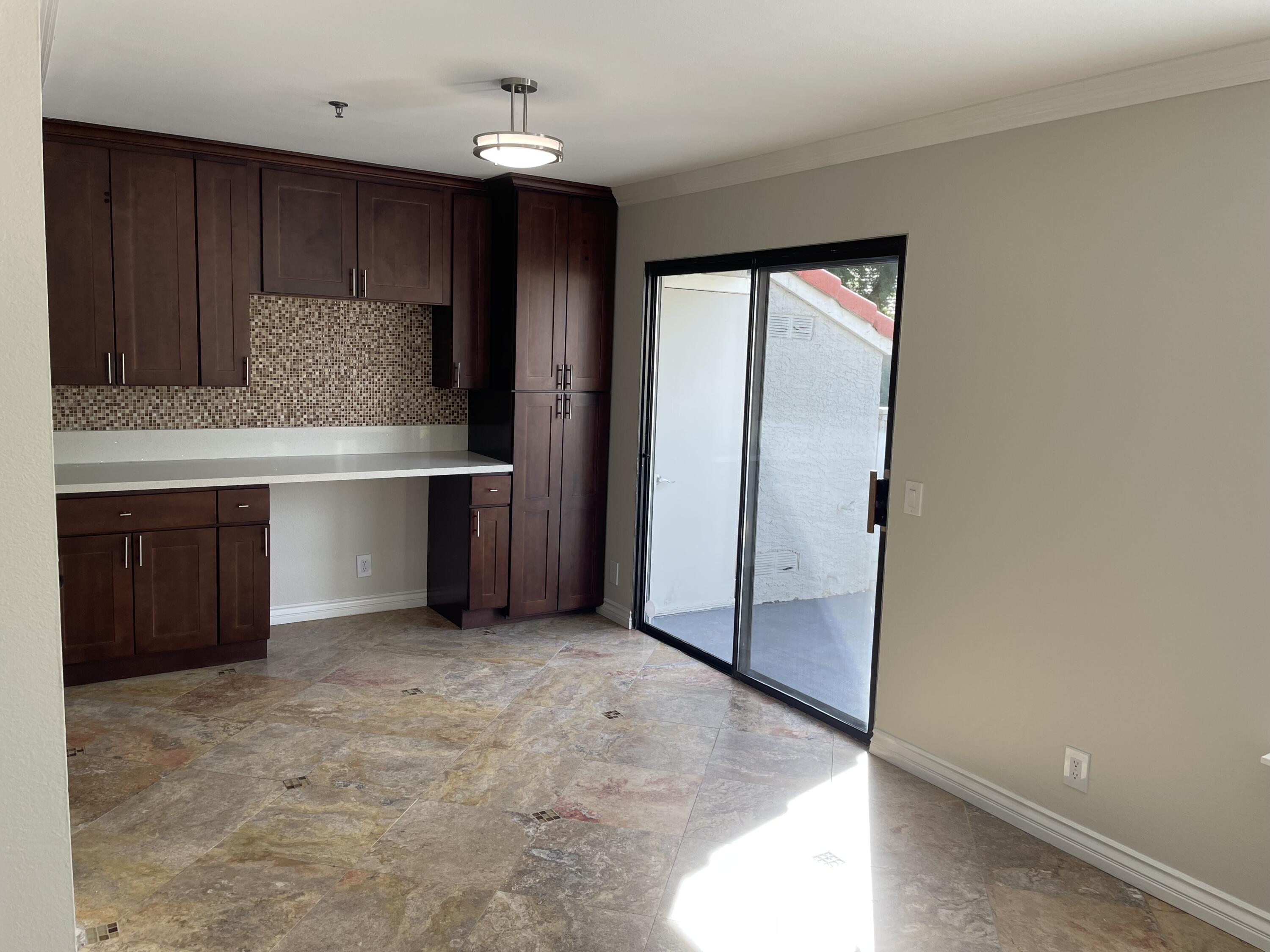 43376 Cook Street, Unit 52 Palm Desert, CA 92211 - Photo 10 of 42 a kitchen with granite countertop a refrigerator and a stove top oven