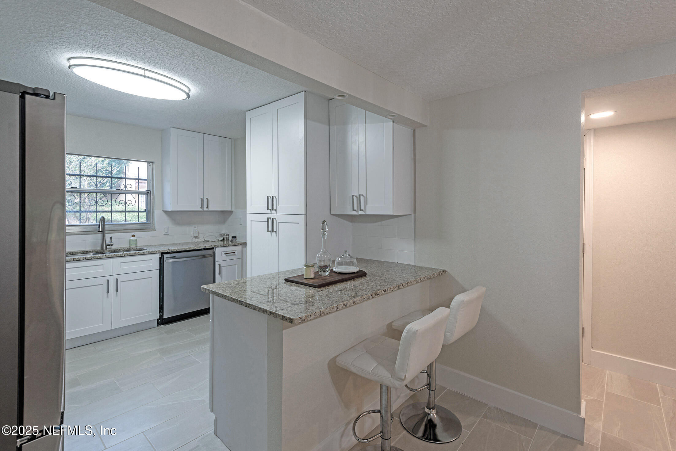 346 Raleigh Road, Unit 346 Jacksonville, FL 32225 - Photo 13 of 43 a kitchen with a sink cabinets and window