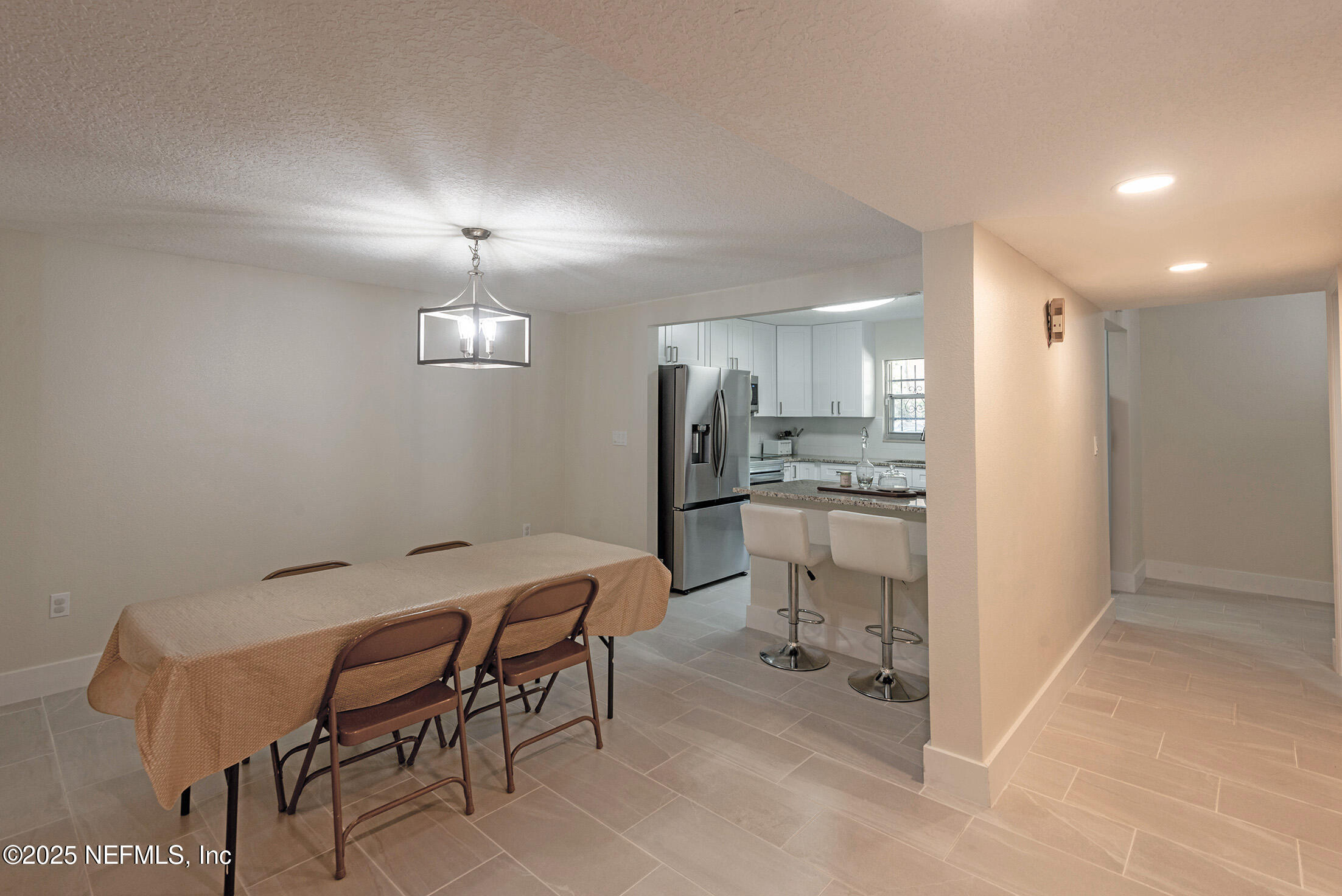 346 Raleigh Road, Unit 346 Jacksonville, FL 32225 - Photo 16 of 43 a kitchen with white cabinets and stainless steel appliances