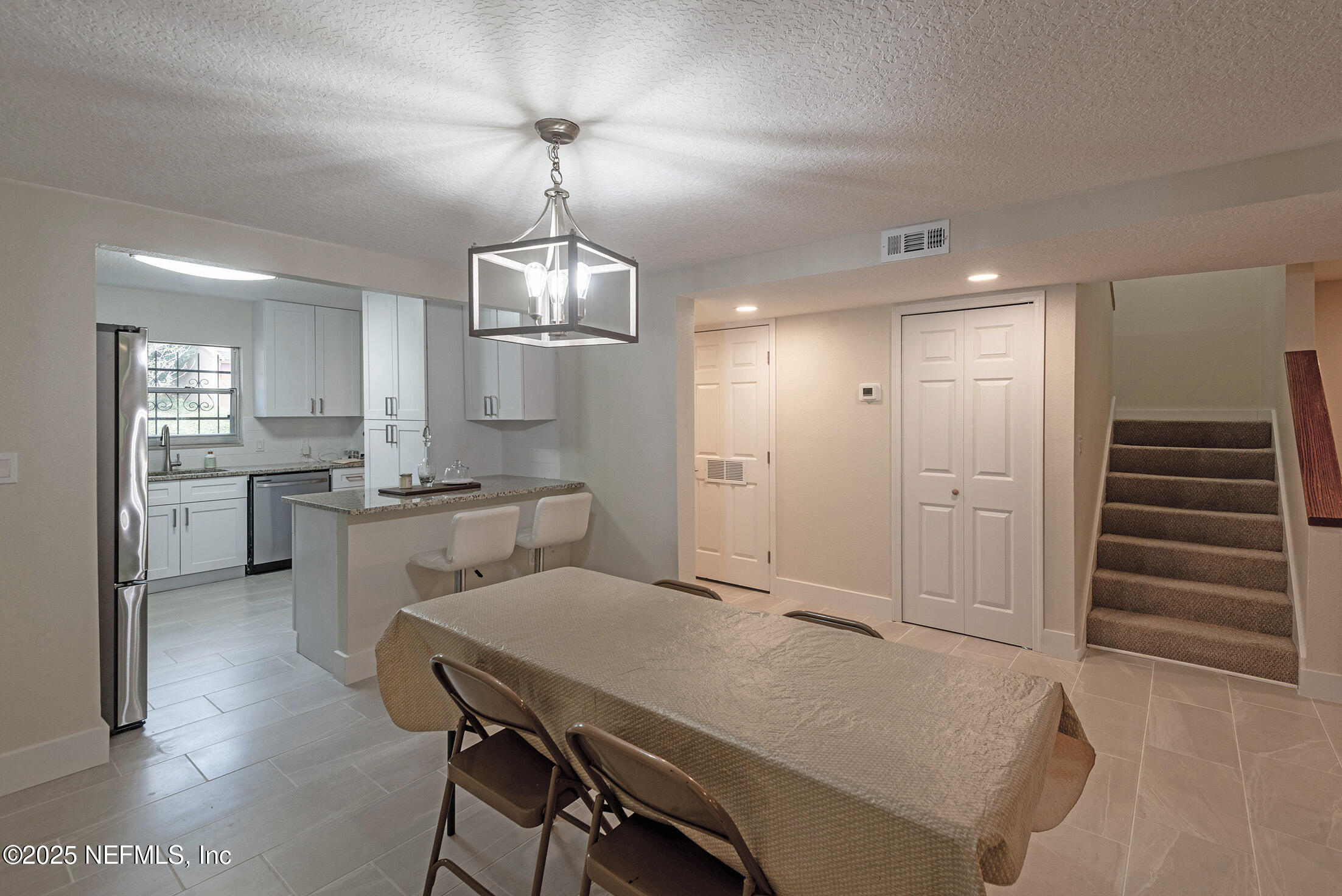 346 Raleigh Road, Unit 346 Jacksonville, FL 32225 - Photo 17 of 43 a open kitchen with white cabinets and stainless steel appliances