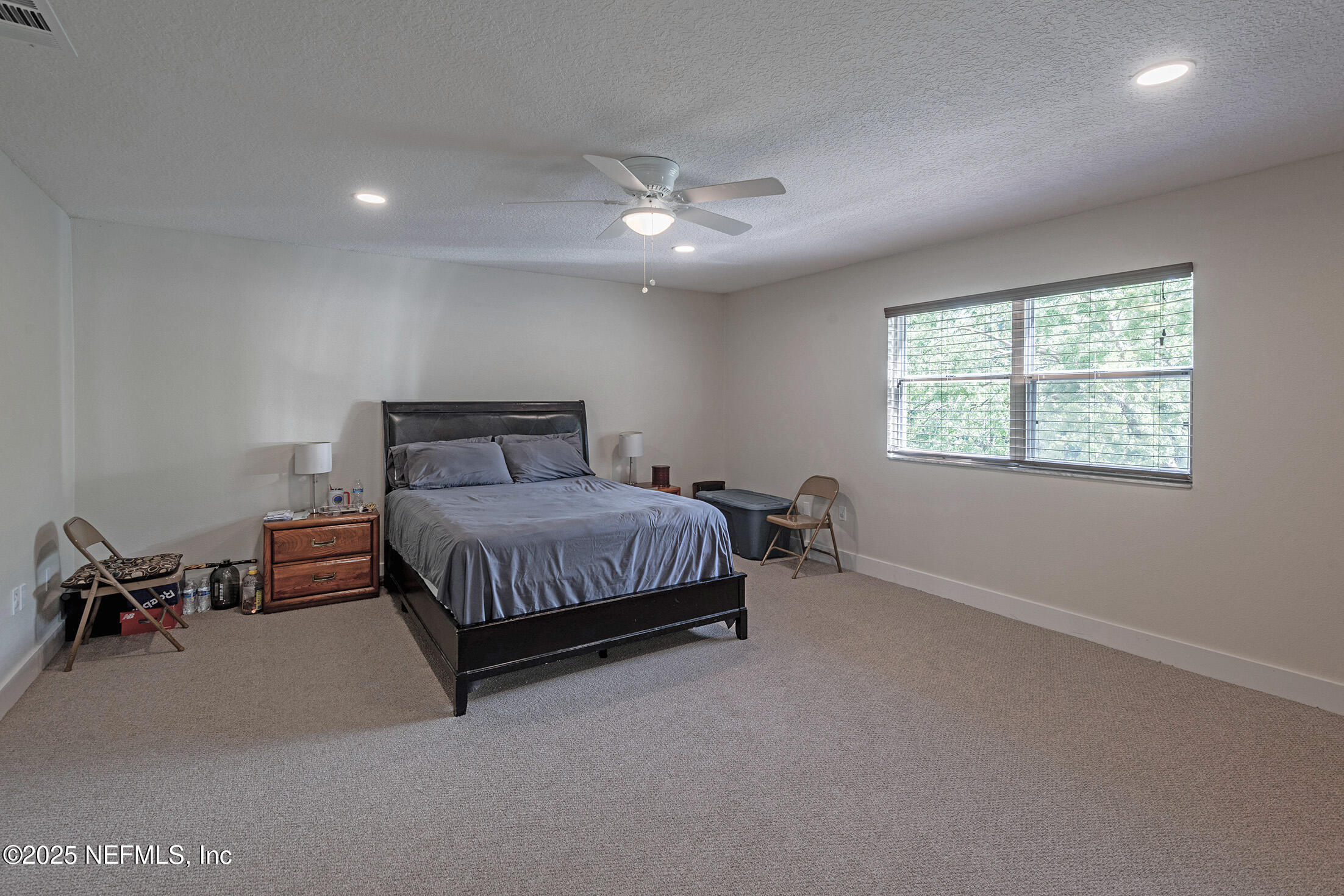 346 Raleigh Road, Unit 346 Jacksonville, FL 32225 - Photo 24 of 43 a bedroom with a bed and a chair