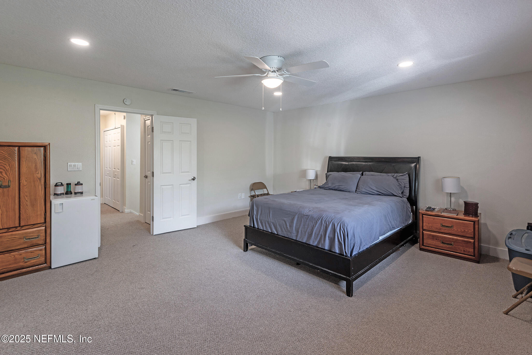 346 Raleigh Road, Unit 346 Jacksonville, FL 32225 - Photo 25 of 43 a spacious bedroom with a bed and a chandelier