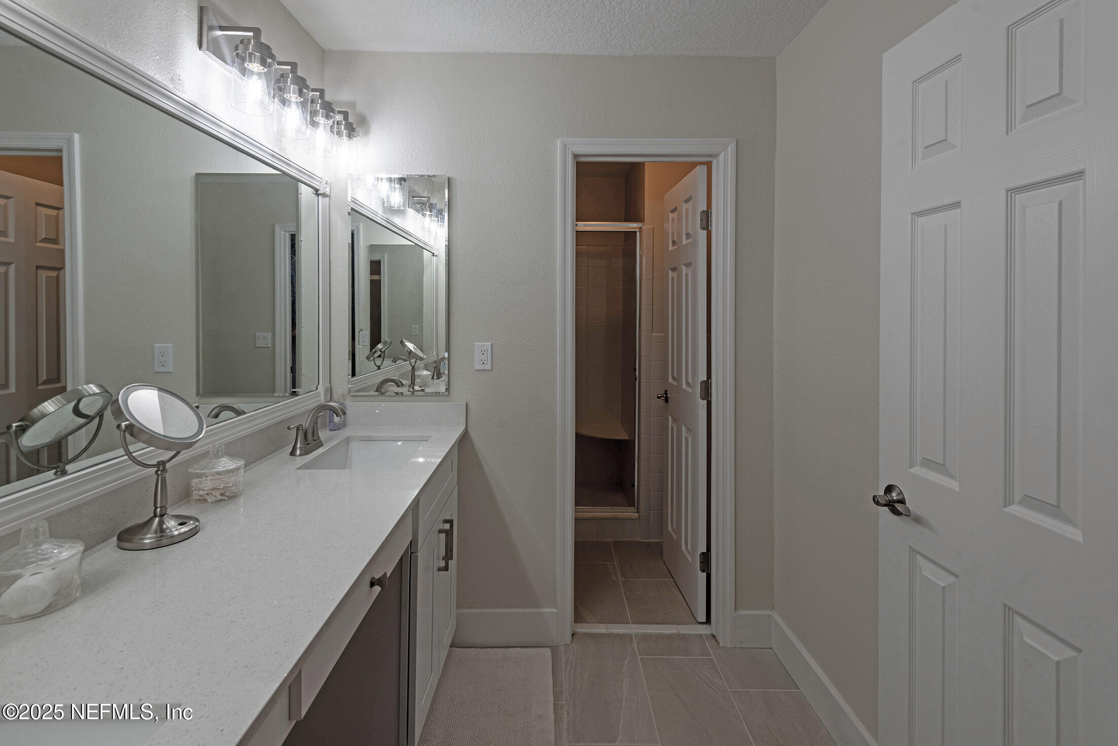 346 Raleigh Road, Unit 346 Jacksonville, FL 32225 - Photo 27 of 43 a bathroom with a double vanity sink and a mirror