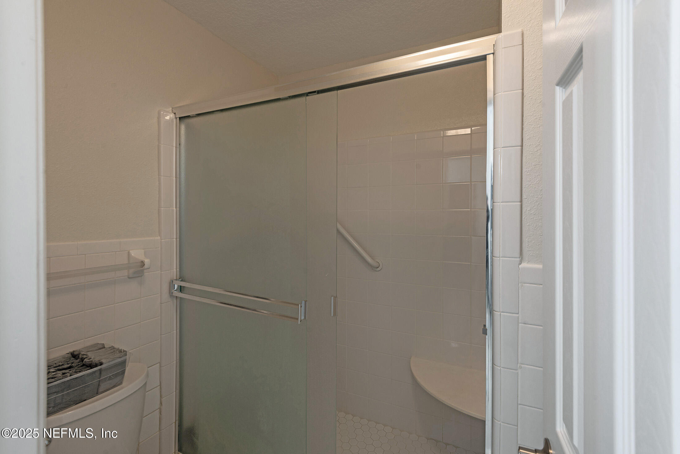 346 Raleigh Road, Unit 346 Jacksonville, FL 32225 - Photo 28 of 43 a bathroom with a glass shower door