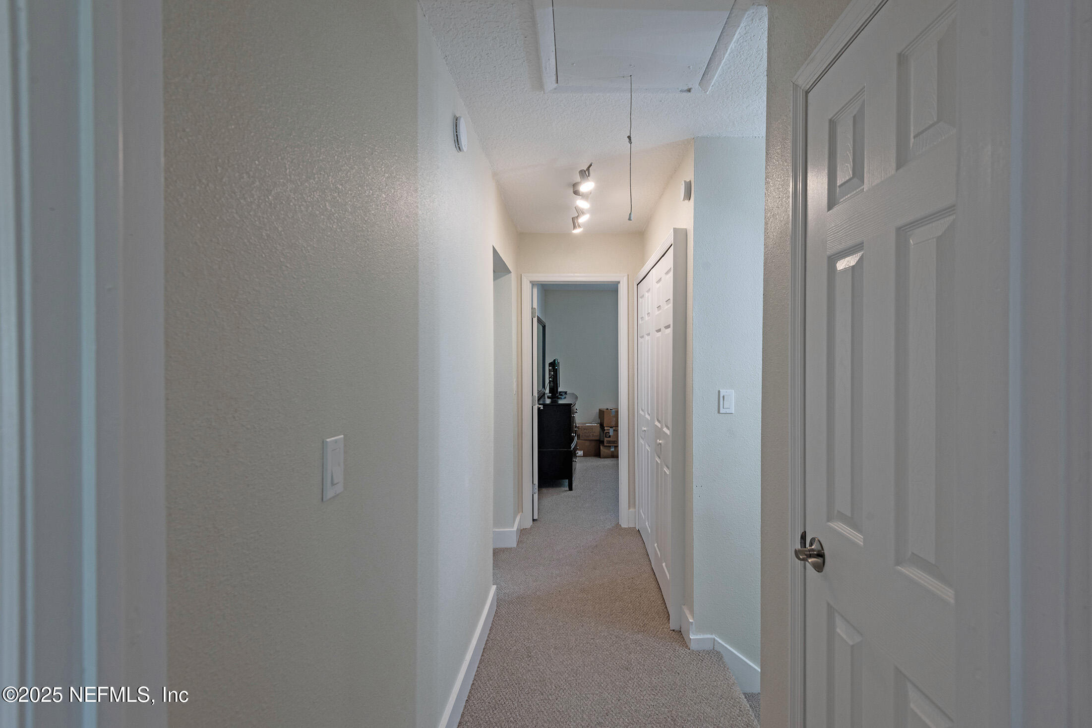 346 Raleigh Road, Unit 346 Jacksonville, FL 32225 - Photo 29 of 43 a view of a hallway with chandelier