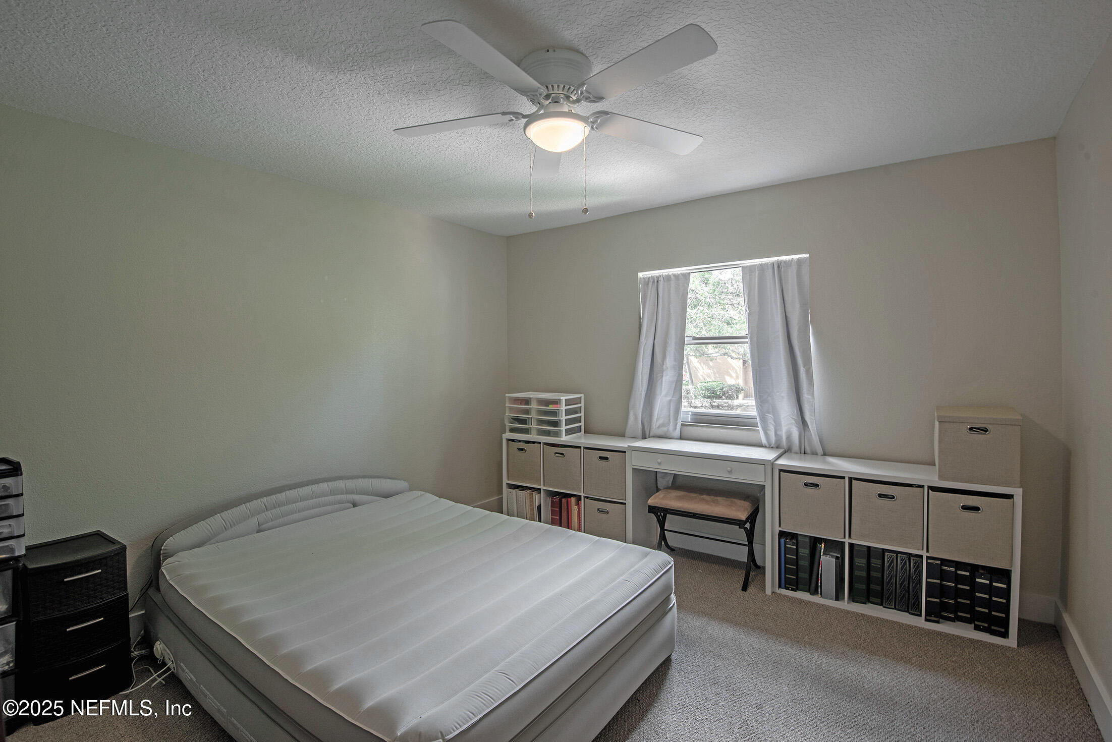 346 Raleigh Road, Unit 346 Jacksonville, FL 32225 - Photo 33 of 43 a bedroom with a bed and a window