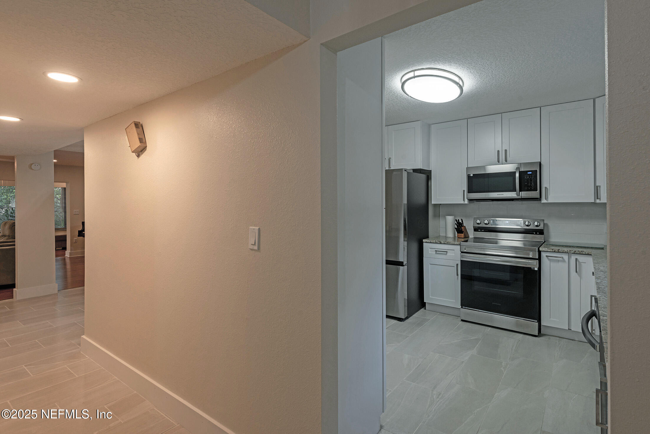 346 Raleigh Road, Unit 346 Jacksonville, FL 32225 - Photo 7 of 43 a kitchen with stainless steel appliances granite countertop a refrigerator and a stove