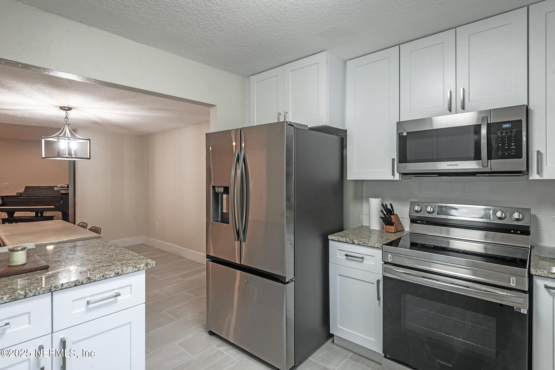 346 Raleigh Road, Unit 346 Jacksonville, FL 32225 - Photo 10 of 43 a kitchen with stainless steel appliances granite countertop a refrigerator stove and microwave