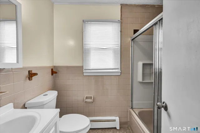 a bathroom with a toilet a sink and bathtub