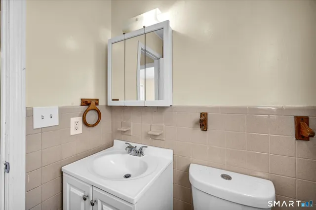 a bathroom with a sink a toilet and mirror