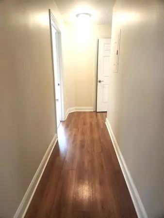 a view of hallway with wooden floor