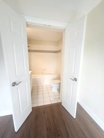 a view of an empty room with wooden floor